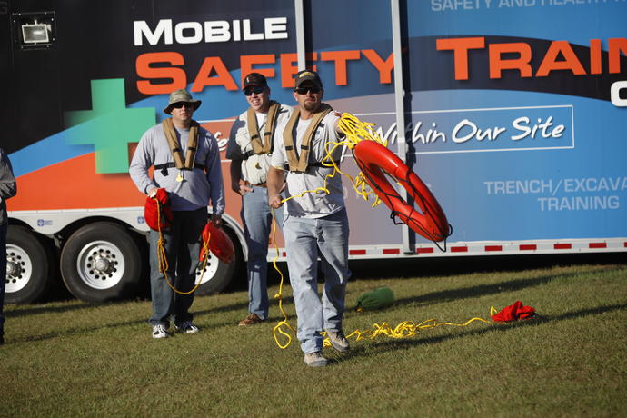 three men using life preservers