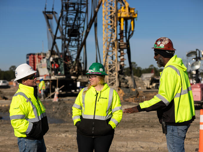 Three employees talking